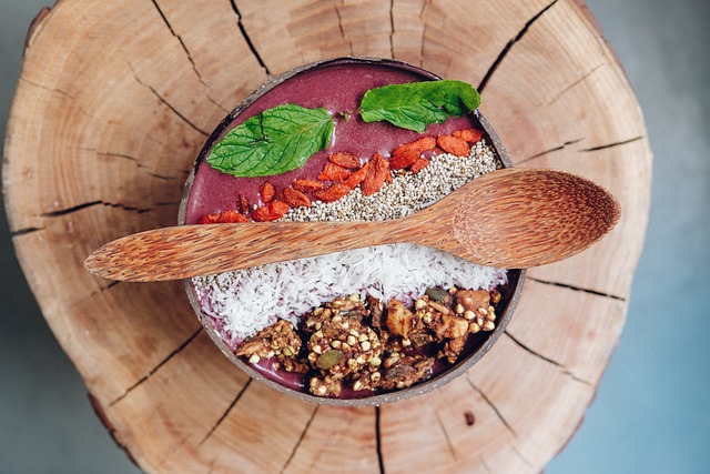 A smoothie bowl  topped with an assortment of grains, nuts, and fruits