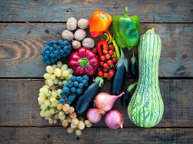 Assorted fruits and vegetables on a wooden surface
