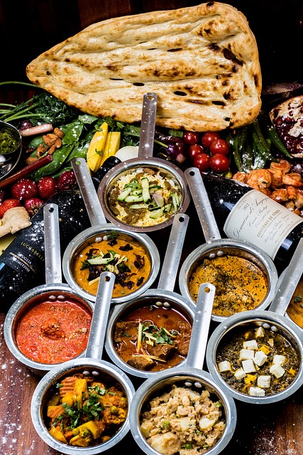 A variety of Indian dips in aluminum bowls served with a flatbread