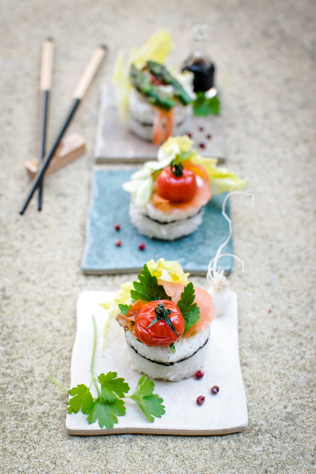 Fusion sushi dishes served on ceramic plates