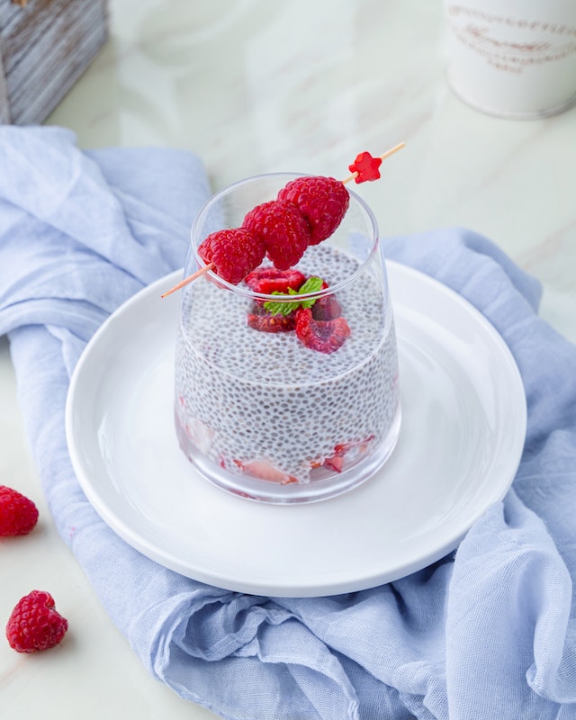 Clear glass with chia seeds and berries inside