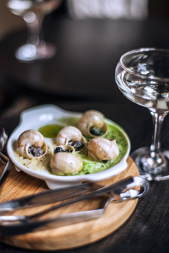 Snails served with a creamy, greenish sauce