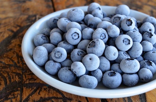 Frozen blueberries in a white bowl