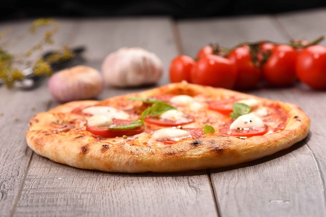 Pizza with tomatoes, basil and mozzarella cheese for toppings