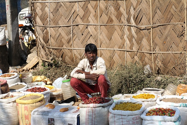 A young street vendor selling a variety of spices