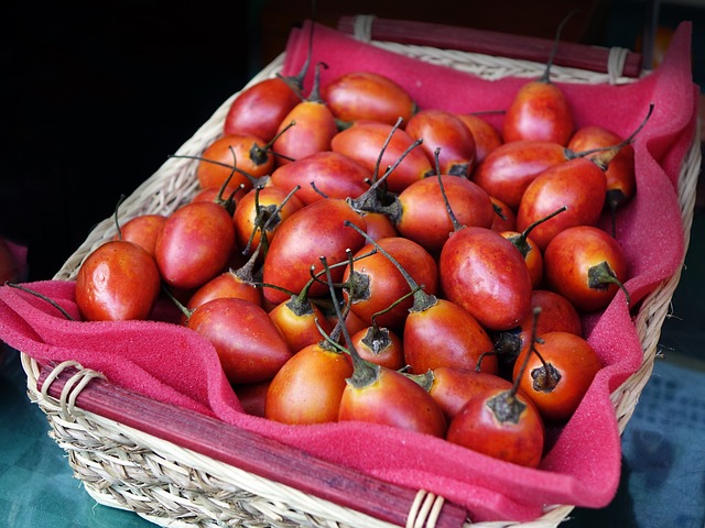 Tamarillo in a woven basket lined with a dark pink foam