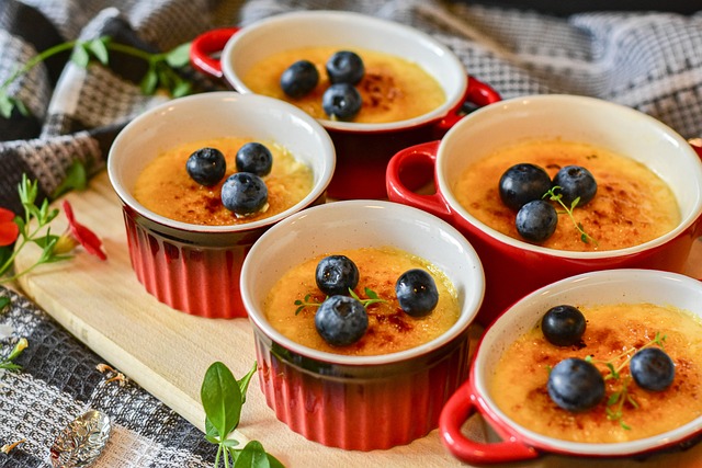 Creme brulee with blueberries topping in red ramekins