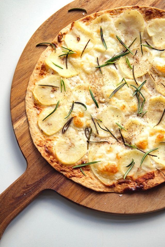 Pizza topped with rosemary leaves