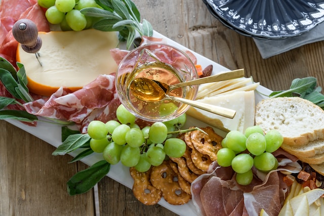 A cheese platter featuring sage leaves