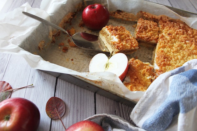 Baked item on a parchment paper-lined baking dish with fresh apples