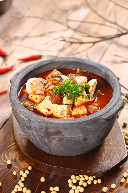 Tofu cubed with red broth served in a ceramic bowl